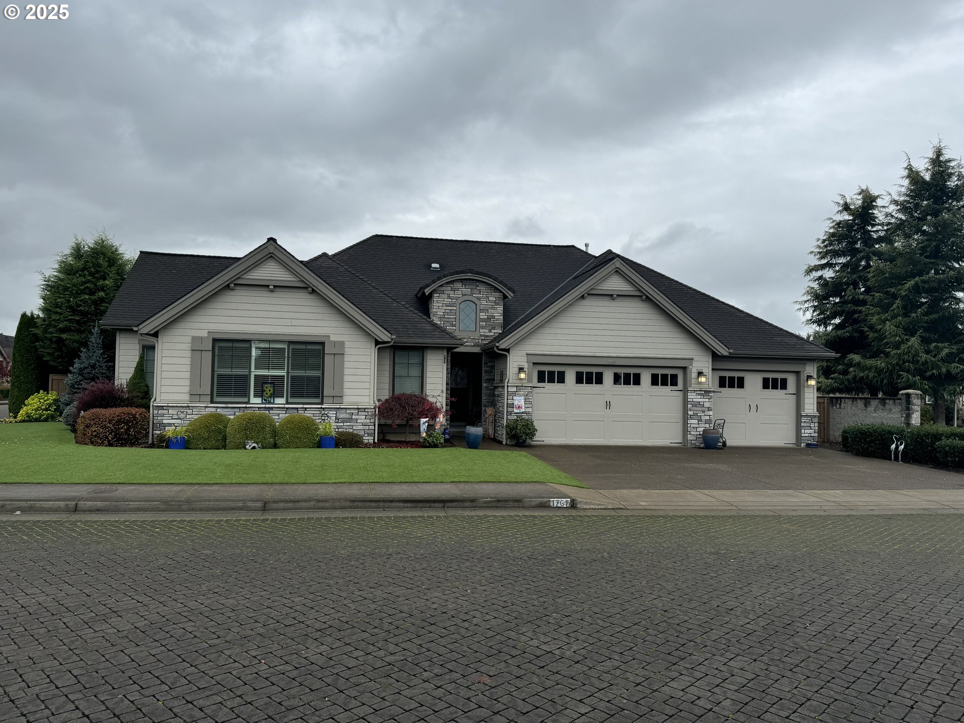 a view of house with a big yard and large trees