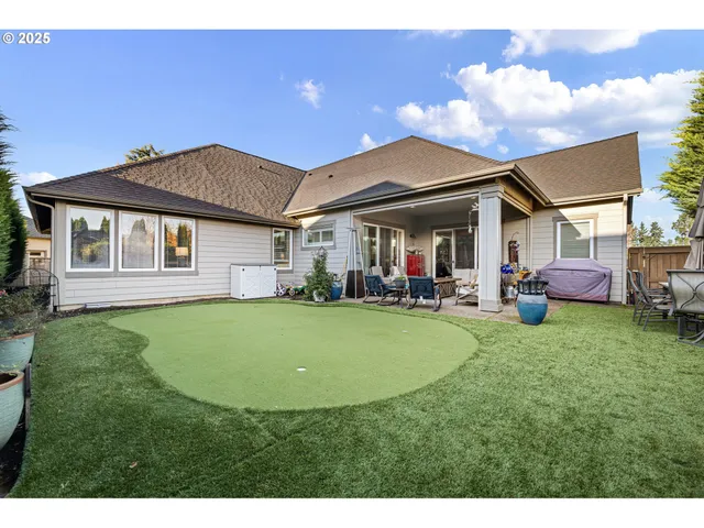 a view of a house with a backyard