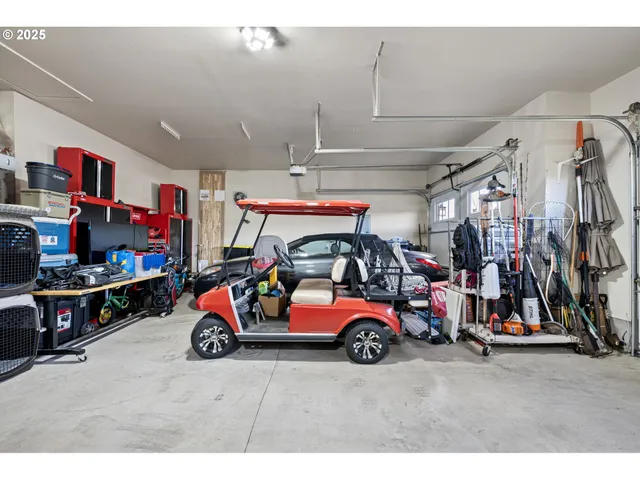 a view of parking garage with cars and other equipment