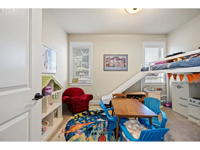 a living room with furniture and a baby crib