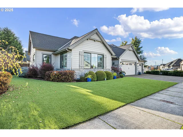 a front view of a house with a garden and yard