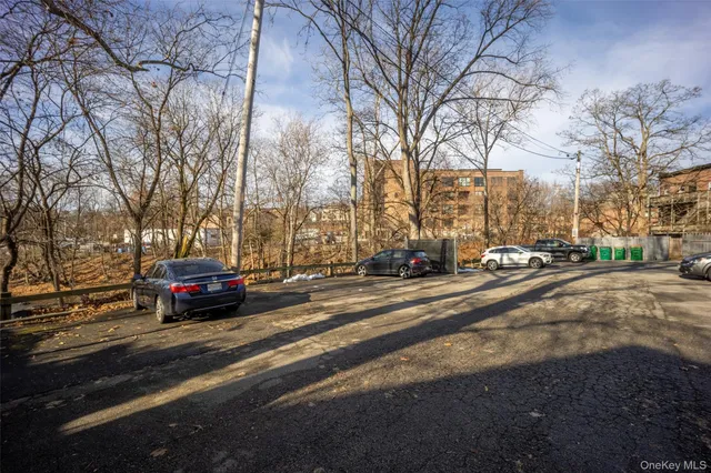 a view of city street with parked cars