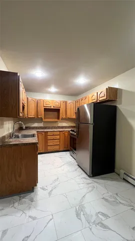 a kitchen with refrigerator and microwave