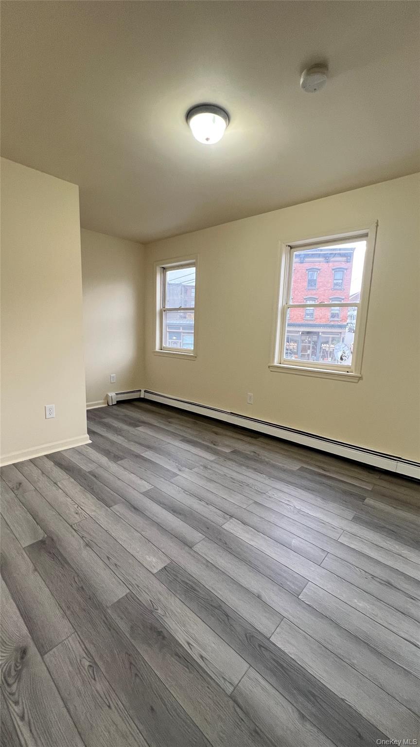 27 East Main Street, Unit 6 Beacon, NY 12508 - Photo 10 of 15 Bedroom 2 with baseboard heating and wood-style finished floors