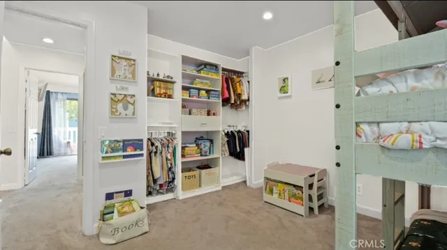 a living room with furniture and a book shelf