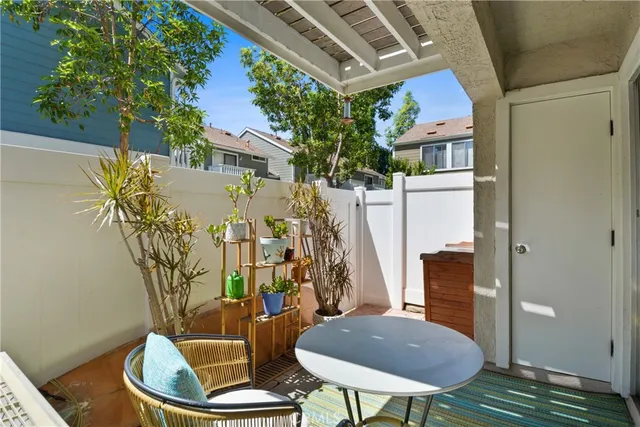 a view of a balcony with chairs and a potted plant