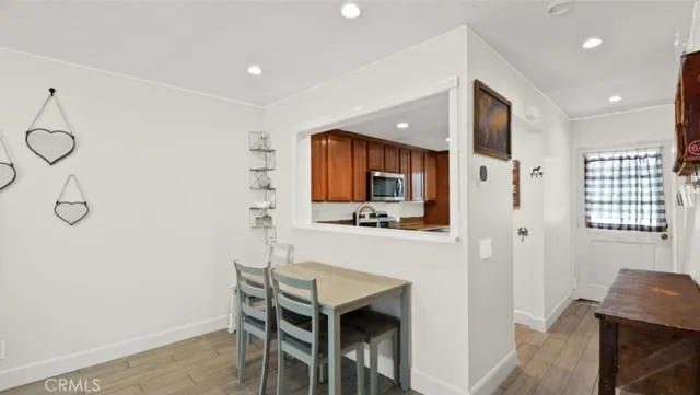 a hallway with a table and chairs