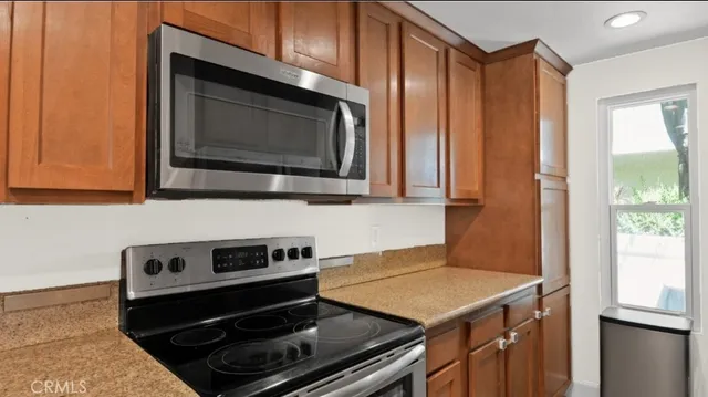 a kitchen with a stove microwave and sink