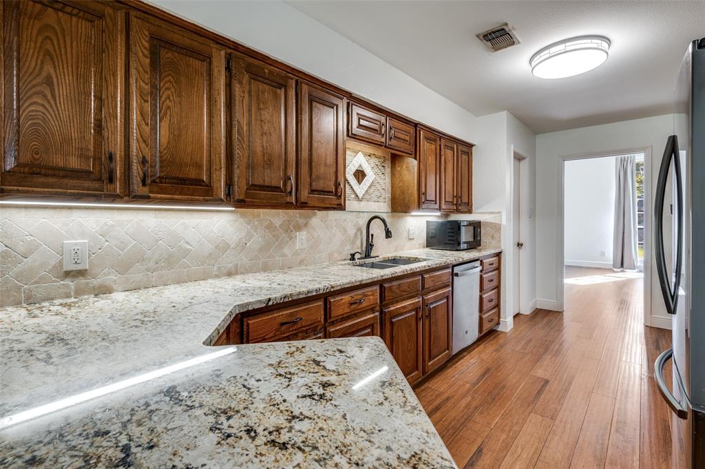 737 Newport Road Fort Worth, TX 76120 - Photo 18 of 37 Another view of Kitchen with solid wood cabinets and granite countertops