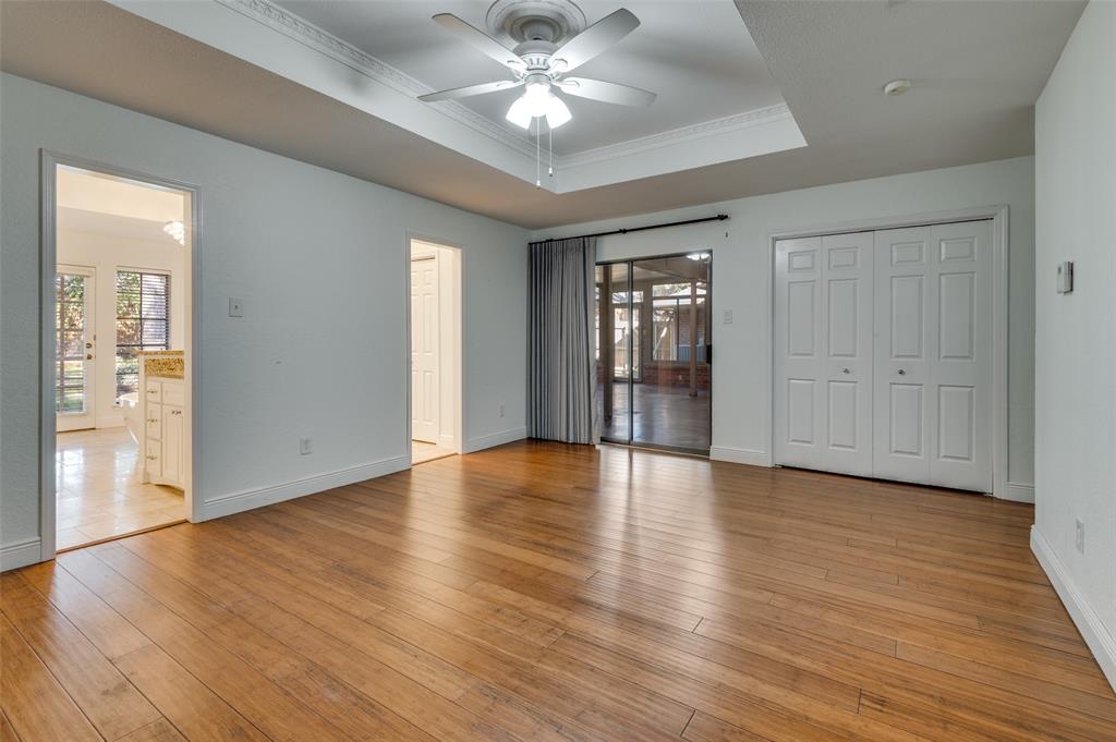 737 Newport Road Fort Worth, TX 76120 - Photo 21 of 37 Primary Bedroom with two openings to the Bathroom and sliding door to the the Sun Room