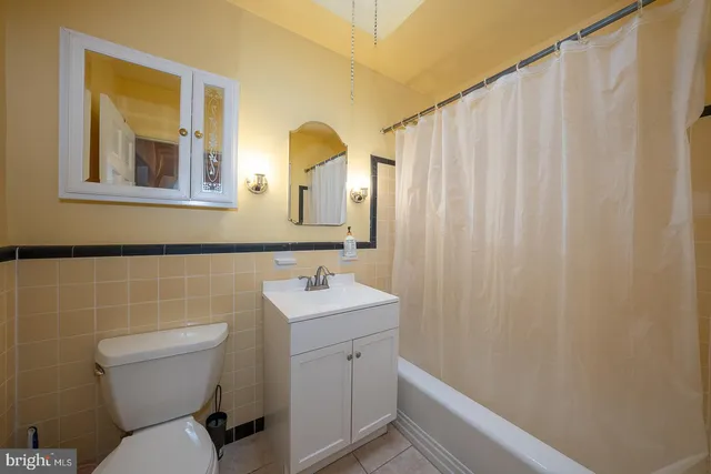 a bathroom with a toilet a sink and a mirror