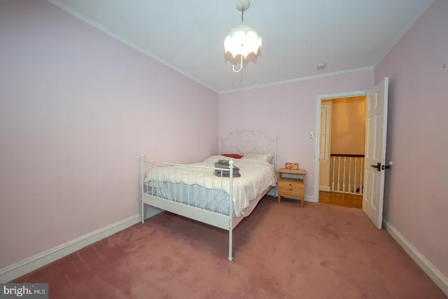 a bed sitting in a room with a chandelier