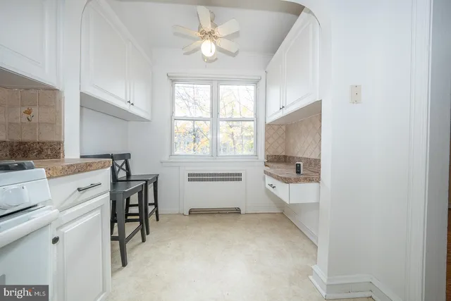 a room with a baby crib furniture and a window