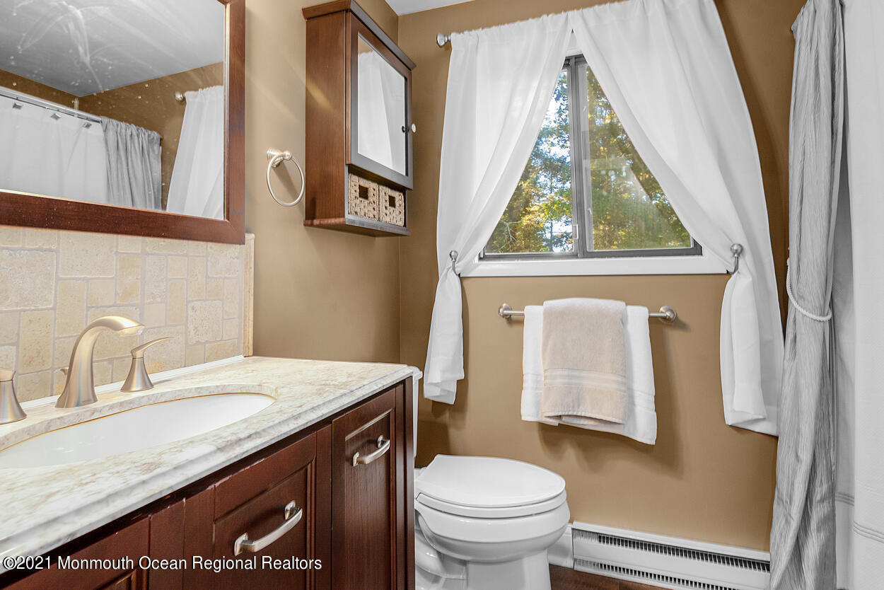 308 New Road Montague, NJ 07827 - Photo 21 of 27 a bathroom with a granite countertop sink toilet and a mirror