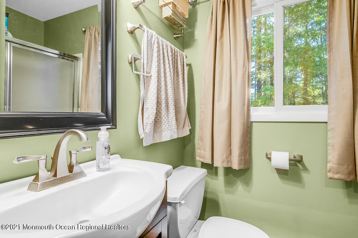 308 New Road Montague, NJ 07827 - Photo 22 of 27 a bathroom with a sink a toilet and a mirror