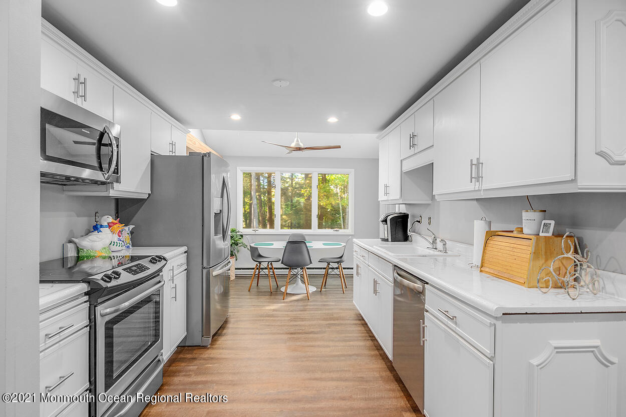 308 New Road Montague, NJ 07827 - Photo 4 of 27 a kitchen with stainless steel appliances a stove a sink a refrigerator and cabinets