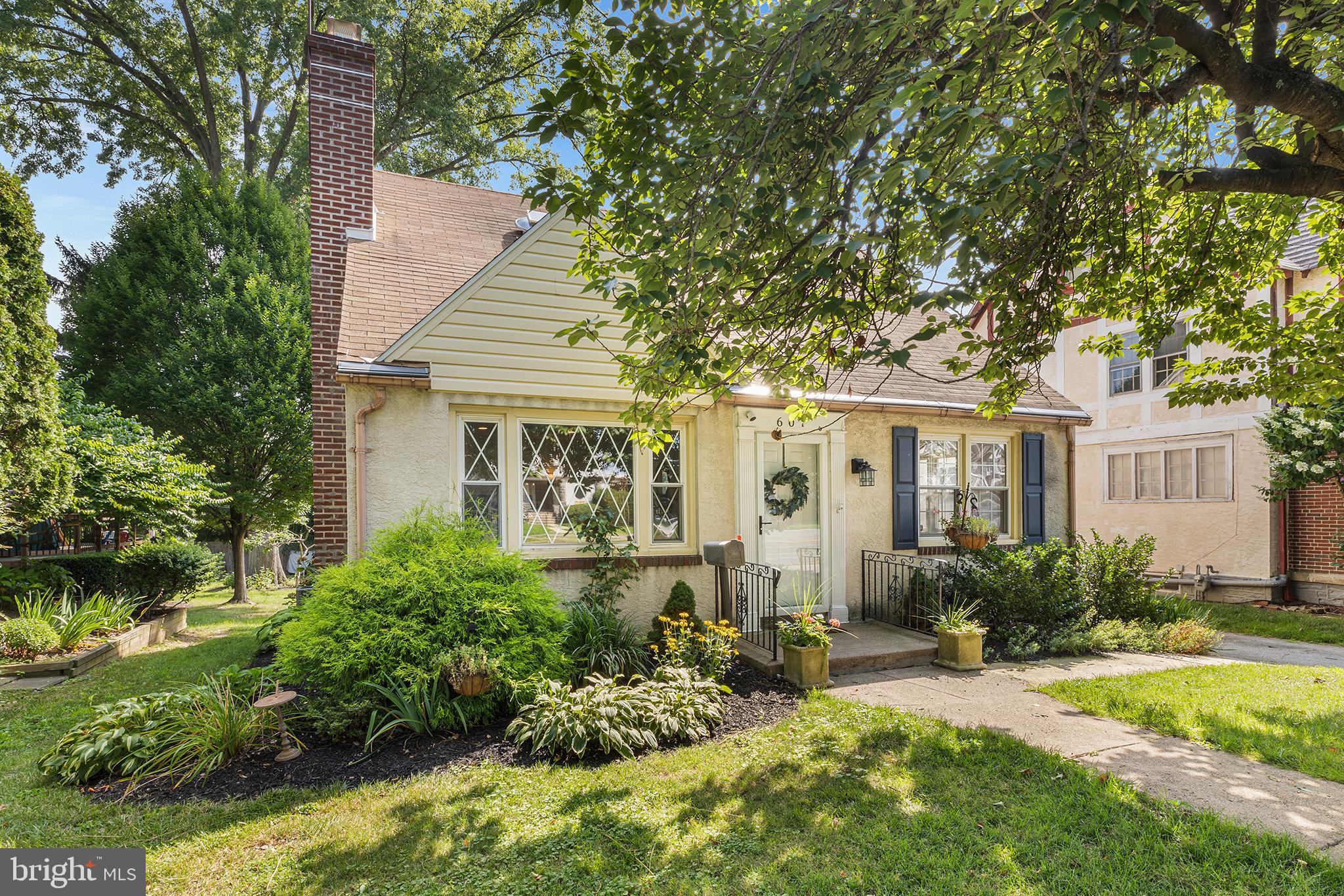 607 Darby Road Havertown, PA 19083 - Photo 1 of 26 a front view of a house with garden