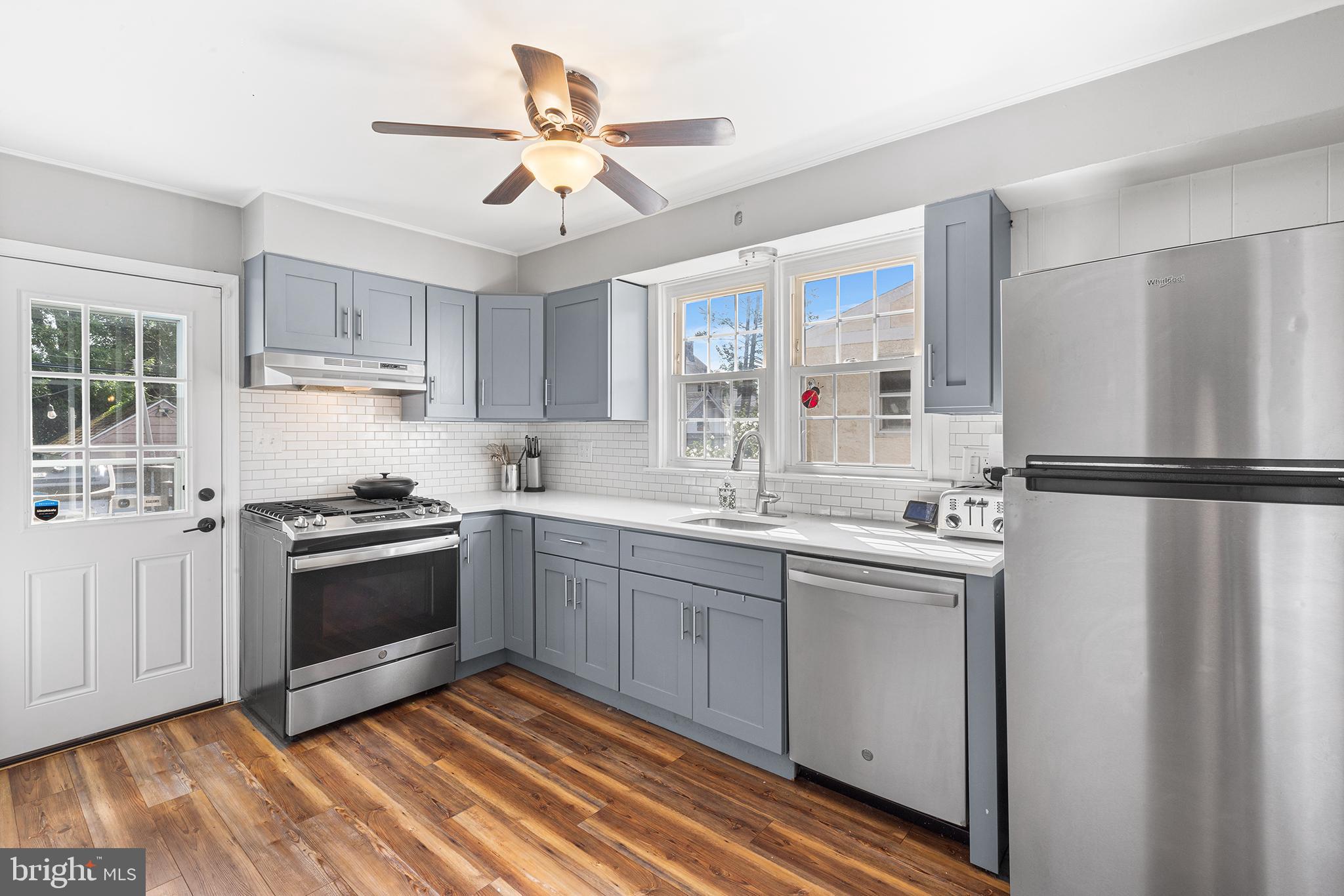 607 Darby Road Havertown, PA 19083 - Photo 8 of 26 a kitchen with stainless steel appliances granite countertop a stove a sink and a refrigerator
