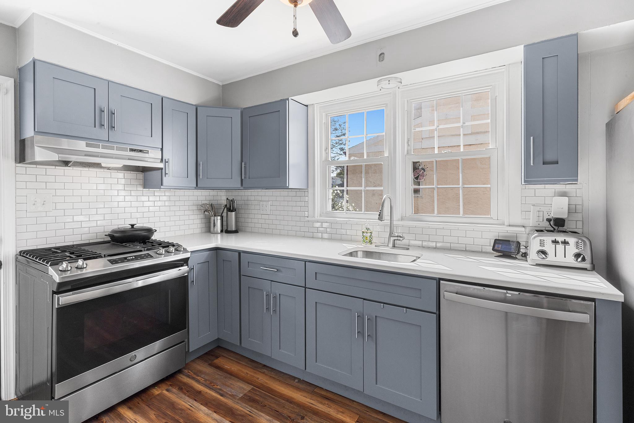 607 Darby Road Havertown, PA 19083 - Photo 10 of 26 a kitchen with stainless steel appliances granite countertop a sink stove and cabinets