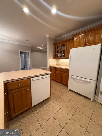 a kitchen with a stove top oven and cabinets