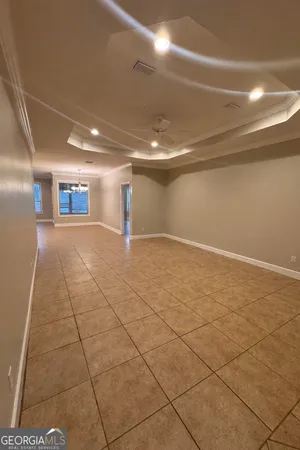 a view of a room with an empty space and window