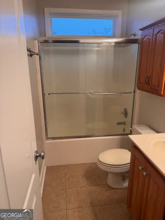 a bathroom with a granite countertop bathtub shower