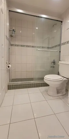 a bathroom with a shower and a toilet