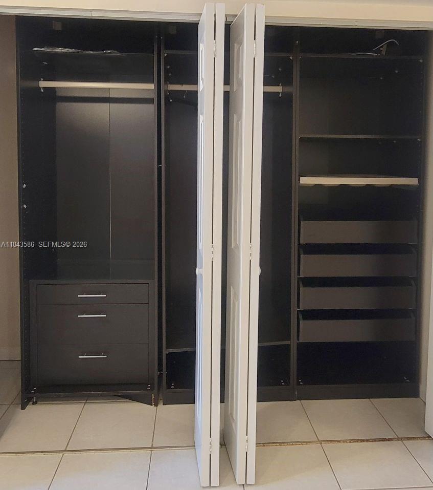 540 Brickell Key Drive, Unit 307 Miami, FL 33131 - Photo 17 of 29 a bathroom with a close shower view and a sink