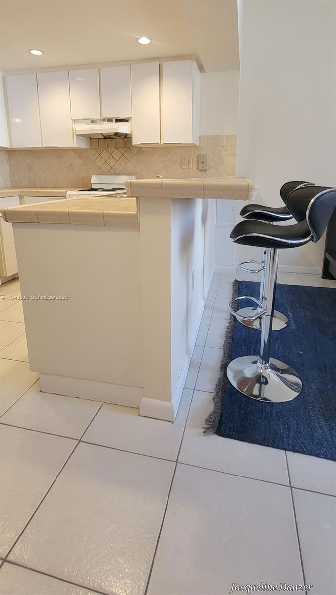 540 Brickell Key Drive, Unit 307 Miami, FL 33131 - Photo 6 of 29 a kitchen with a refrigerator a stove and cabinets