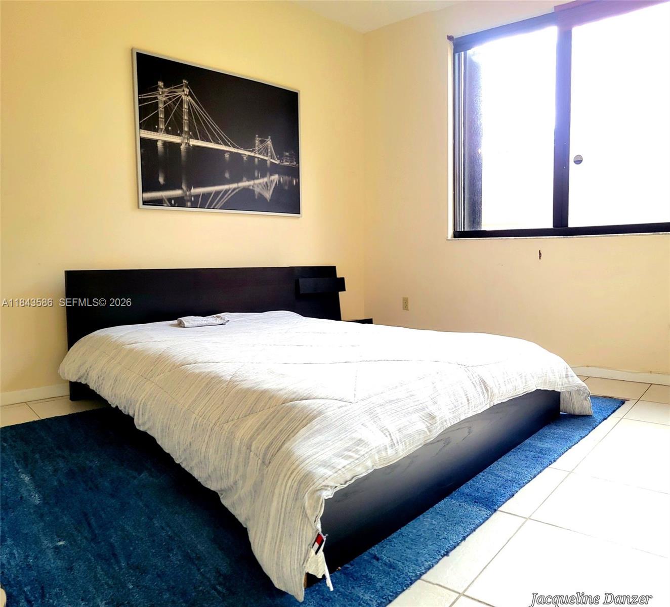 540 Brickell Key Drive, Unit 307 Miami, FL 33131 - Photo 9 of 29 a bedroom with a bed and wooden floor