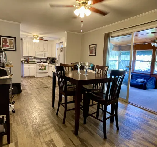 a view of a dining room with furniture and wooden floor