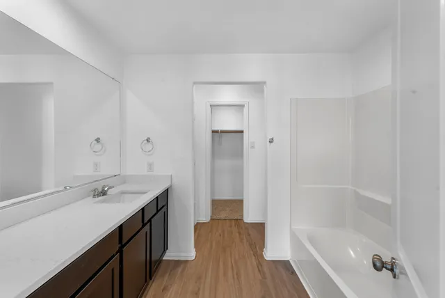 a bathroom with a bathtub and a sink
