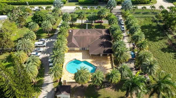 an aerial view of a house with a yard basket ball court and outdoor seating