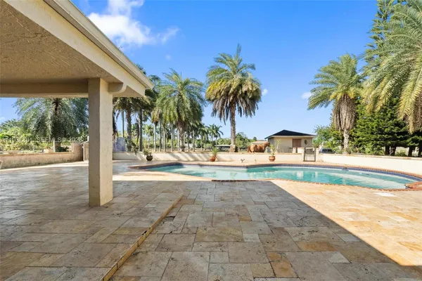 a dining room with furniture water view and a floor to ceiling window