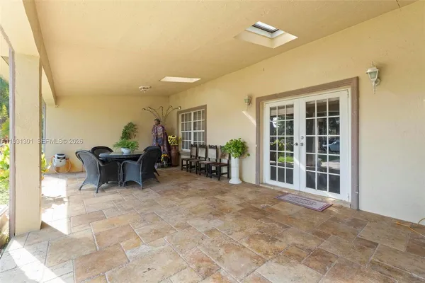 a view of a house with swimming pool and sitting area