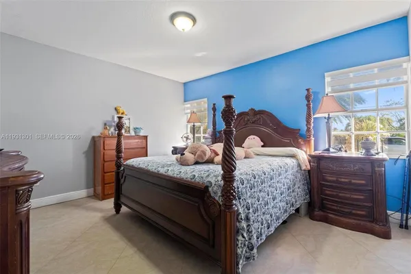 a bedroom with a bed and flat screen tv
