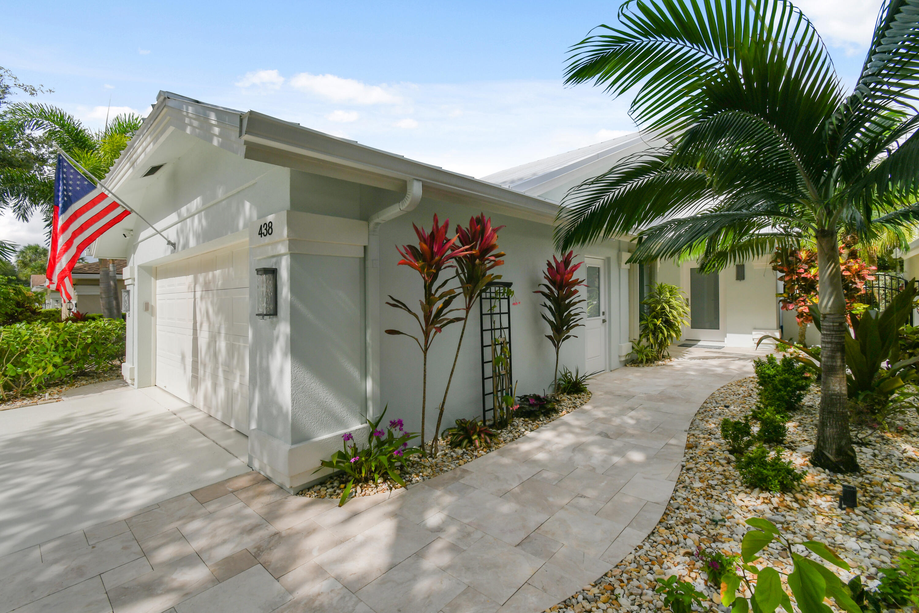 a front view of a house with a plant