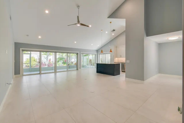 a living room with furniture and a dining table with kitchen view
