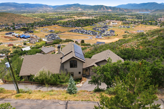 335 Bern Way Midway, UT 84049 - Photo 30 of 88 Hillside property featuring a multi-level design, solar panel installation, a prominent chimney, and a paved driveway
