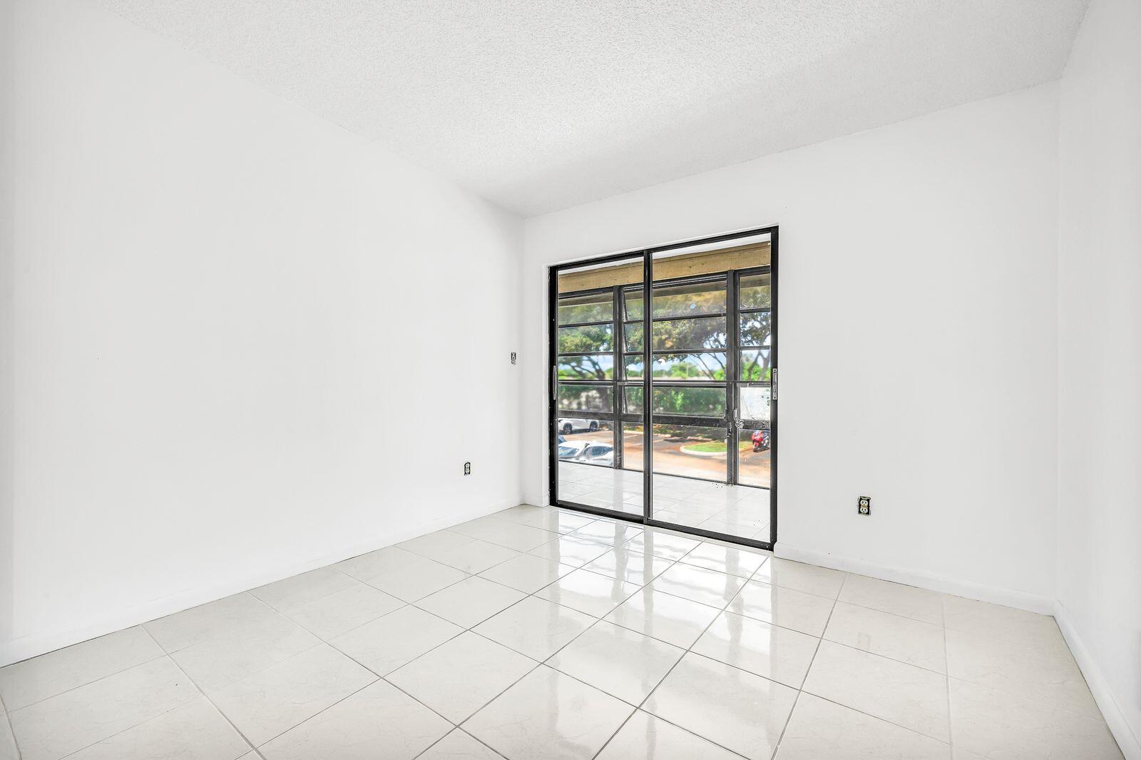 9743 West McNab Road, Unit 209 Tamarac, FL 33321 - Photo 11 of 22 a view of an empty room with a window