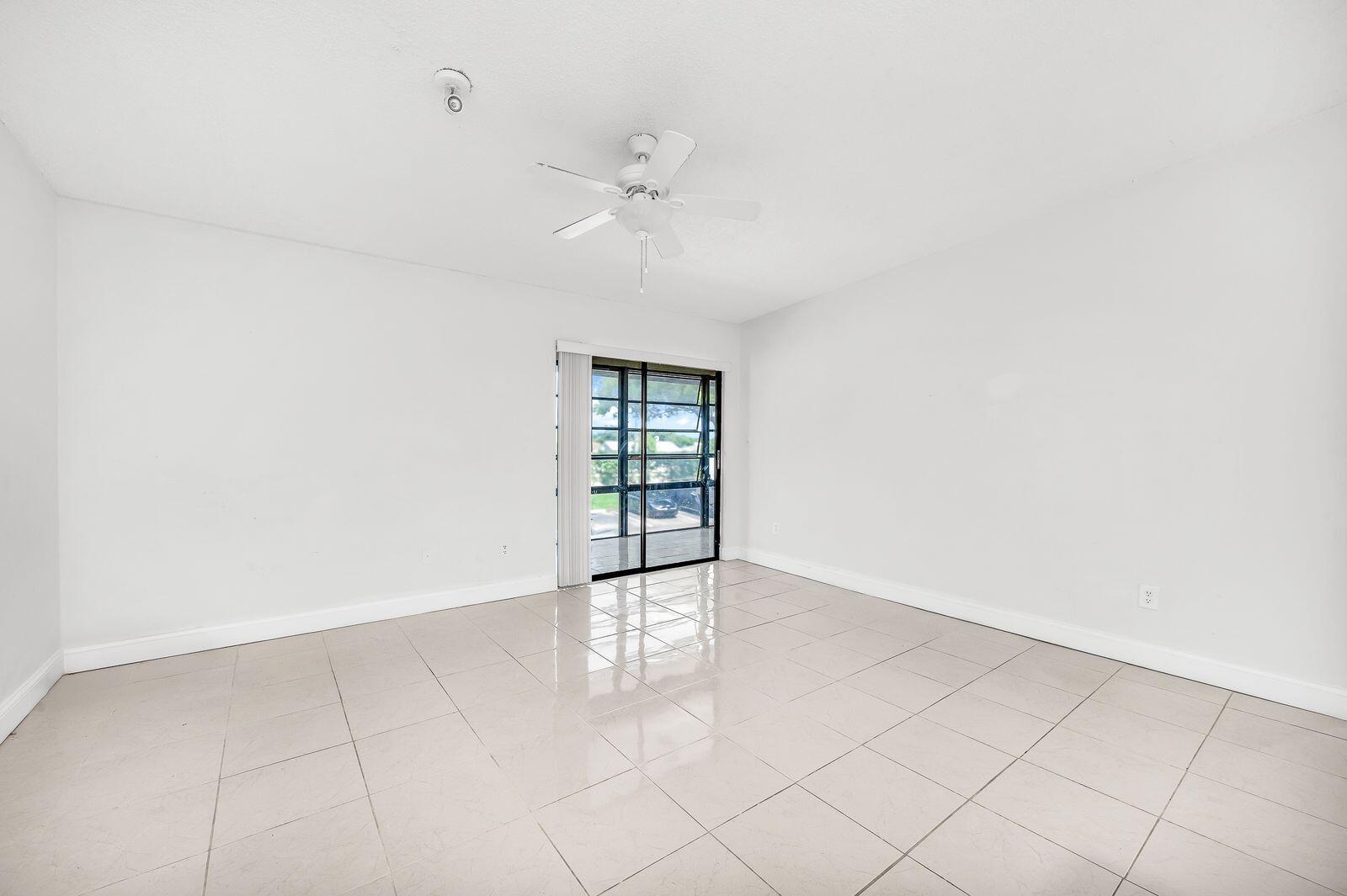 9743 West McNab Road, Unit 209 Tamarac, FL 33321 - Photo 12 of 22 an empty room with fan and windows