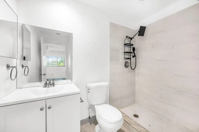 a bathroom with a sink toilet and shower