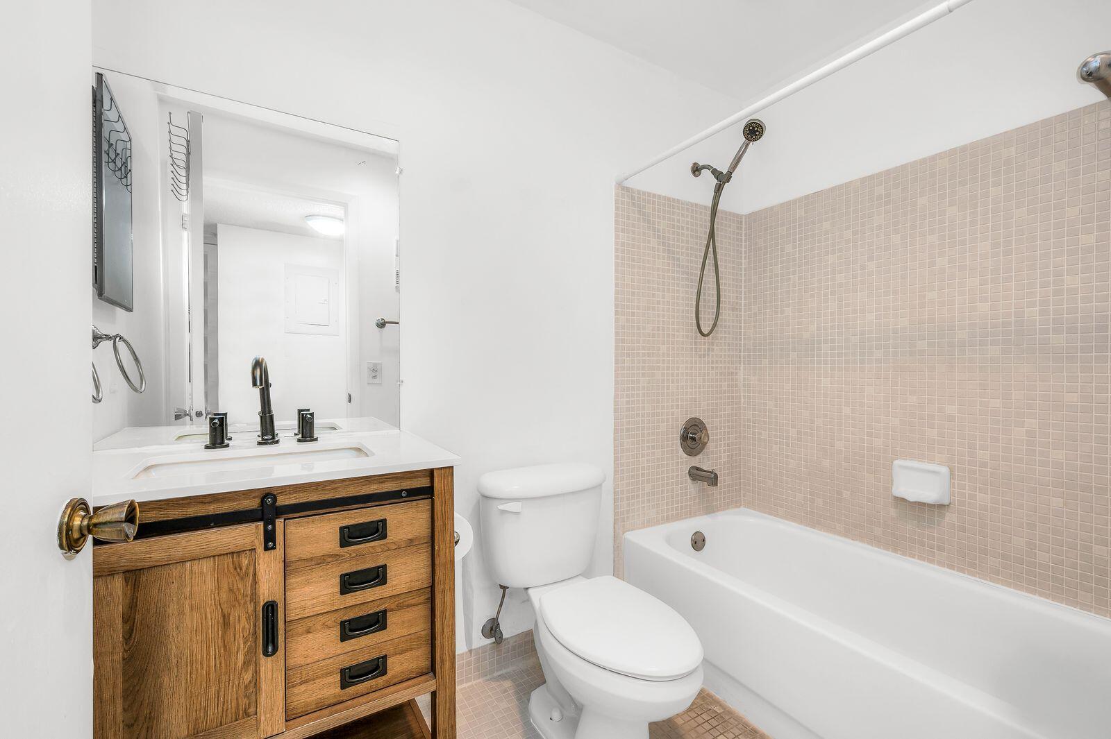 9743 West McNab Road, Unit 209 Tamarac, FL 33321 - Photo 17 of 22 a bathroom with a sink toilet vanity and shower