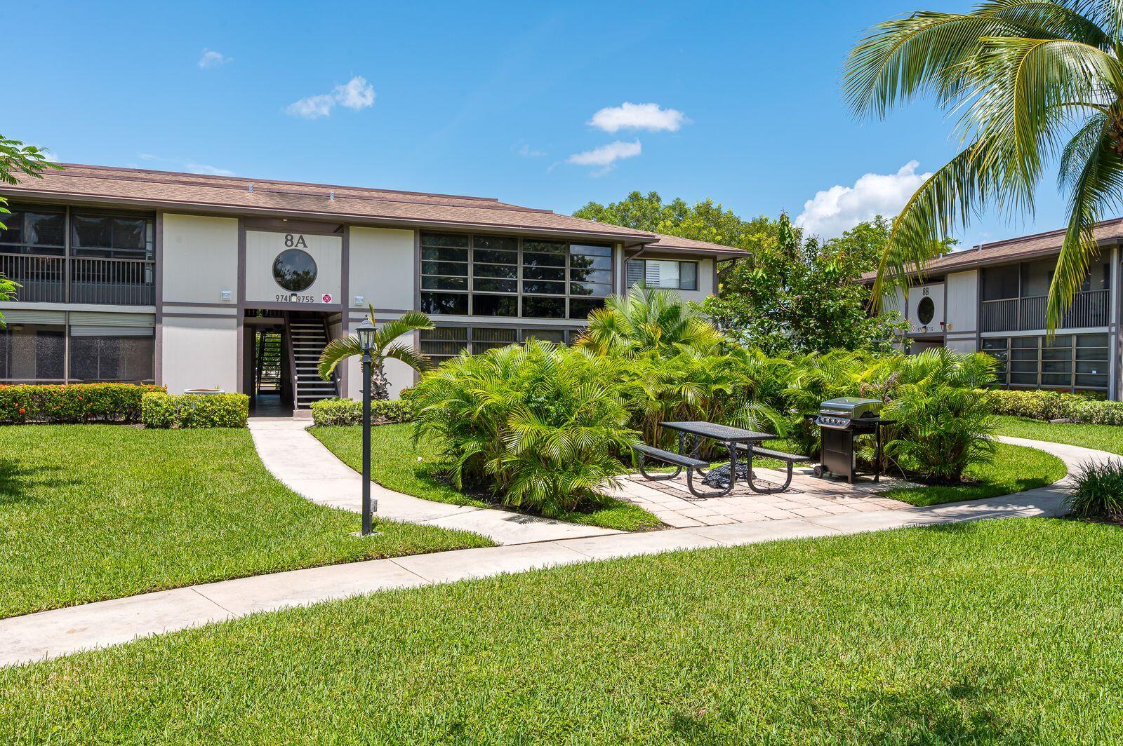 9743 West McNab Road, Unit 209 Tamarac, FL 33321 - Photo 2 of 22 a view of a chair and table in front of house