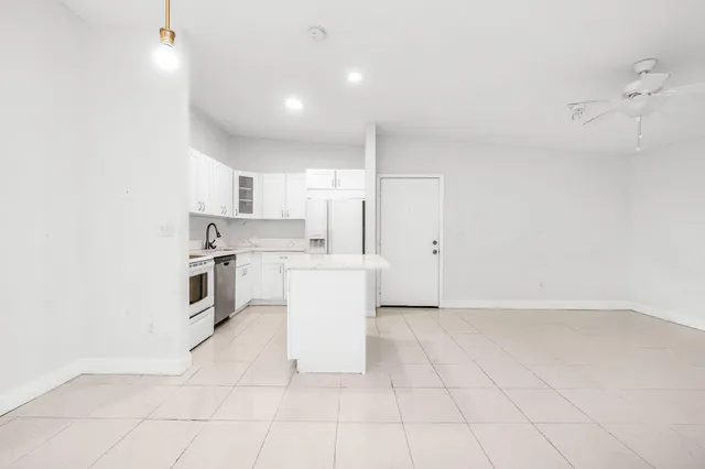 a kitchen with cabinets and white appliances