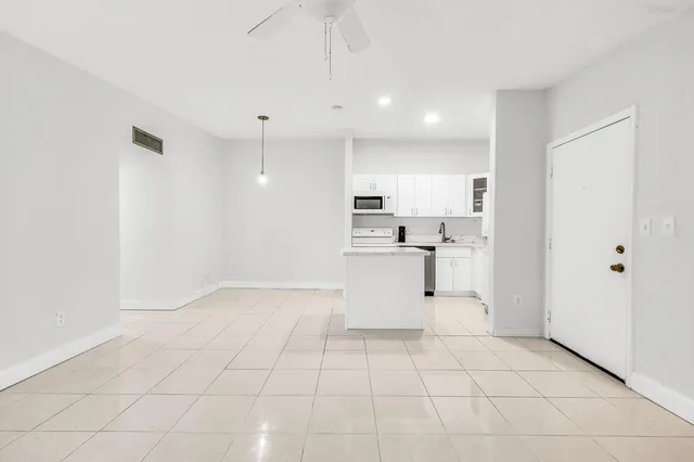 a view of kitchen with white cabinets