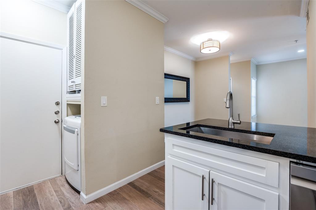 2601 Preston Road, Unit 3103 Plano, TX 75093 - Photo 15 of 30 Full size washer & Dryer area. Entry accessible through garage. Garage has additional shelving and storage area.