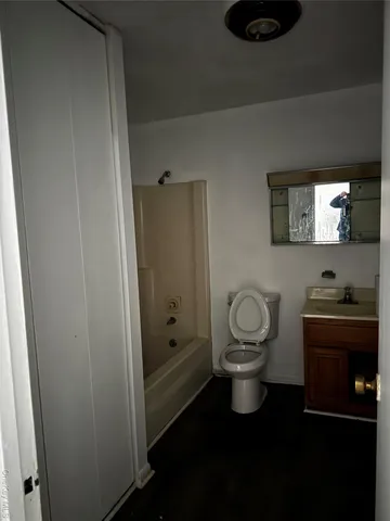 a bathroom with a toilet a sink and mirror