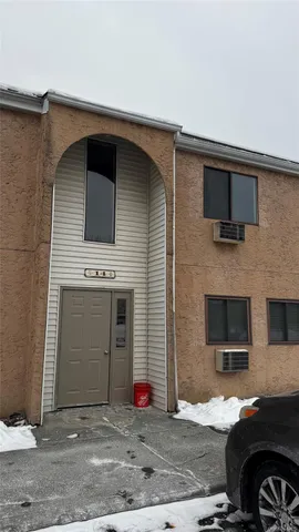 a front view of a house with parking space