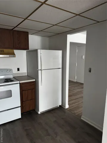 a kitchen with a refrigerator and a stove